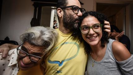 Alaa Abd El-Fattah celebrates, 22 September 2025. (Photo: Picture Alliance/dpa/M. El Raai) A man and two women hug in celebration