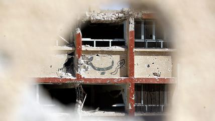 Adra, northeast of Damascus, Syria. (Photo: picture alliance / dpa | Youssef Badawi) The word “freedom” written on a demolished house